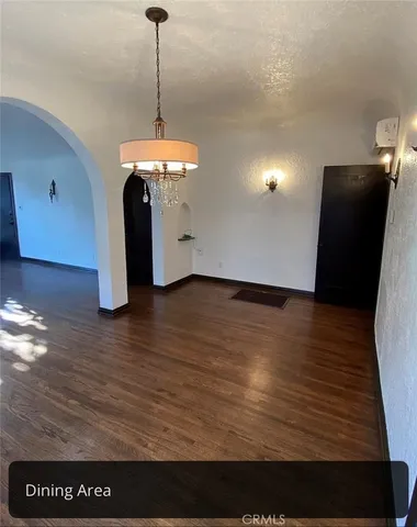 a view of an empty room and wooden floor