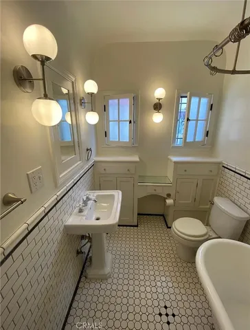 a kitchen with a sink a stove and cabinets