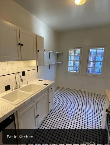 a kitchen with stainless steel appliances granite countertop a sink and a stove