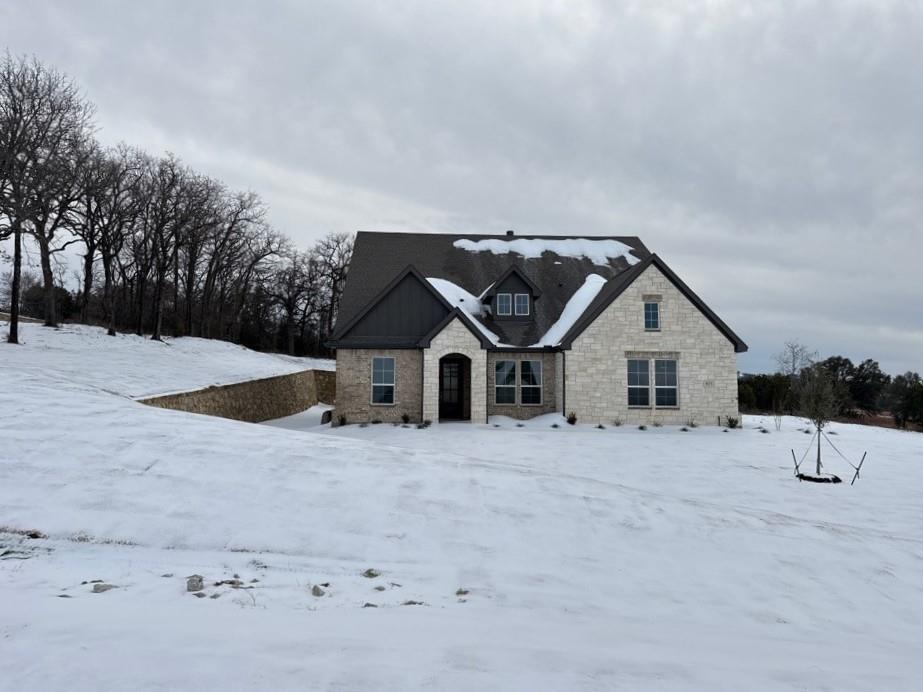 a view of a house with a snow in the yard