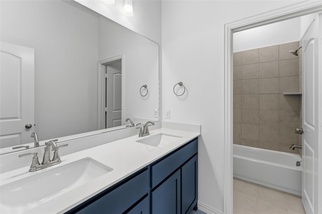 405 Hayden Faith Court Springtown, TX 76082 - Photo 12 of 30 a bathroom with a double vanity sink mirror and bathtub