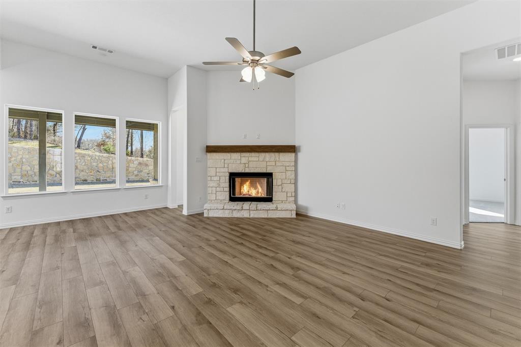 405 Hayden Faith Court Springtown, TX 76082 - Photo 18 of 30 a view of an empty room with wooden floor and a window