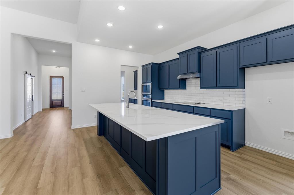 405 Hayden Faith Court Springtown, TX 76082 - Photo 19 of 30 a kitchen with kitchen island sink stove and refrigerator