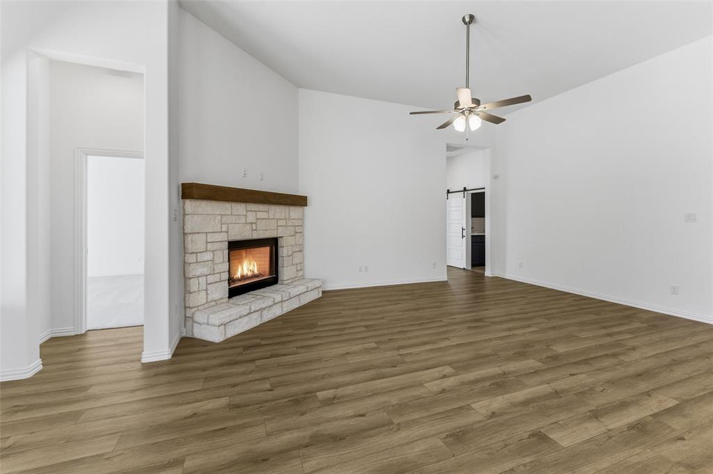 405 Hayden Faith Court Springtown, TX 76082 - Photo 21 of 30 a view of empty room with wooden floor and fireplace