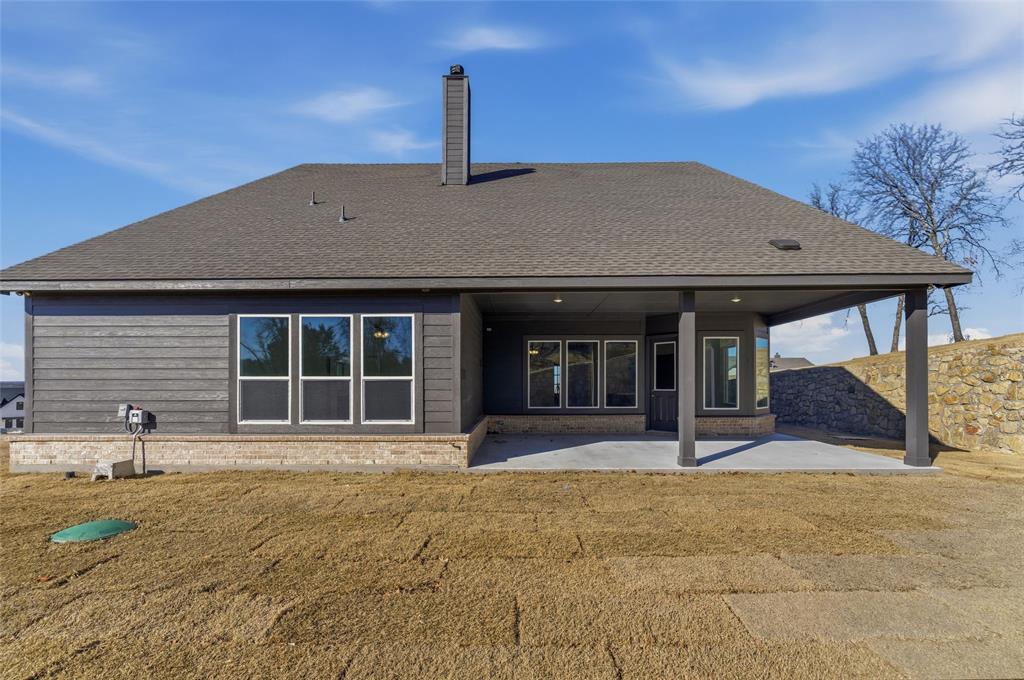 405 Hayden Faith Court Springtown, TX 76082 - Photo 27 of 30 a front view of a building with garden