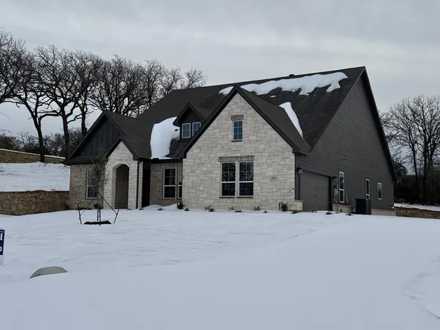 a view of a house with snow on the road