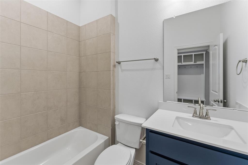405 Hayden Faith Court Springtown, TX 76082 - Photo 9 of 30 a bathroom with a sink toilet vanity and shower