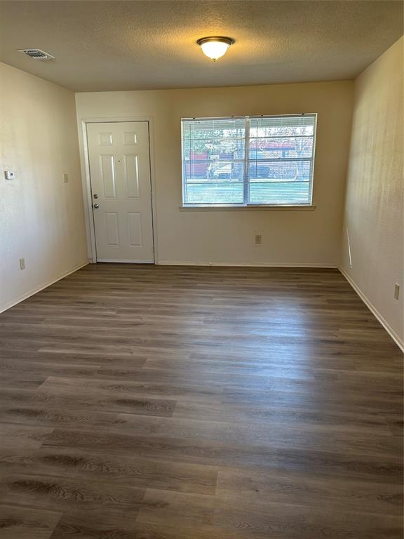 1836 Coral Road Pelican Bay, TX 76020 - Photo 4 of 13 an empty room with wooden floor and windows