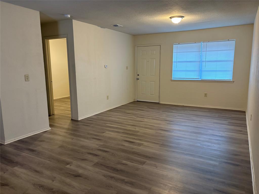 1836 Coral Road Pelican Bay, TX 76020 - Photo 5 of 13 an empty room with wooden floor and windows