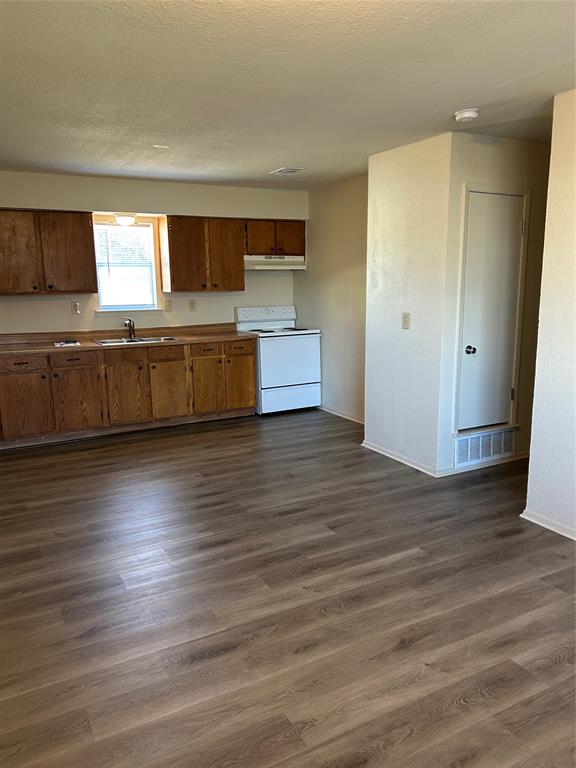 1836 Coral Road Pelican Bay, TX 76020 - Photo 6 of 13 a view of kitchen and microwave with wooden floor