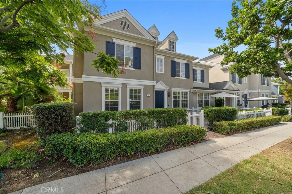 a front view of a residential houses with yard and green space