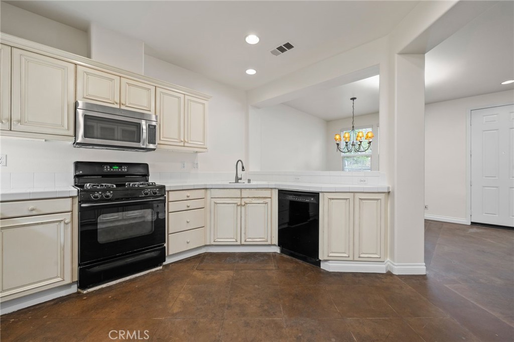 3 Wildflower Place Ladera Ranch, CA 92694 - Photo 13 of 32 a kitchen with granite countertop a stove top oven microwave and cabinets
