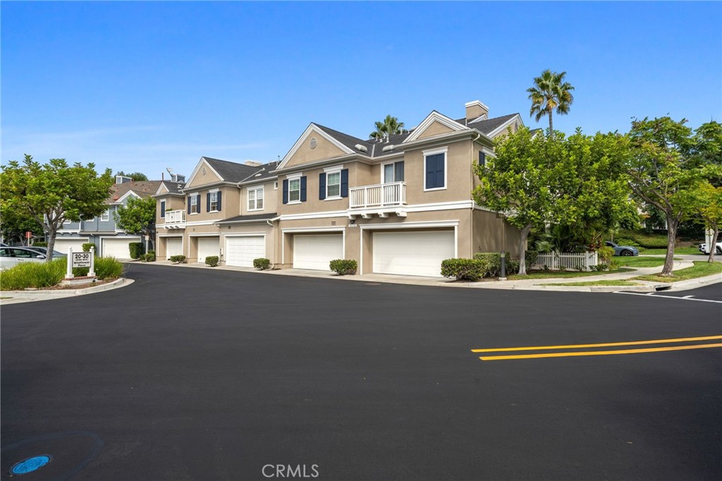 3 Wildflower Place Ladera Ranch, CA 92694 - Photo 2 of 32 a front view of a house with a garden and street view