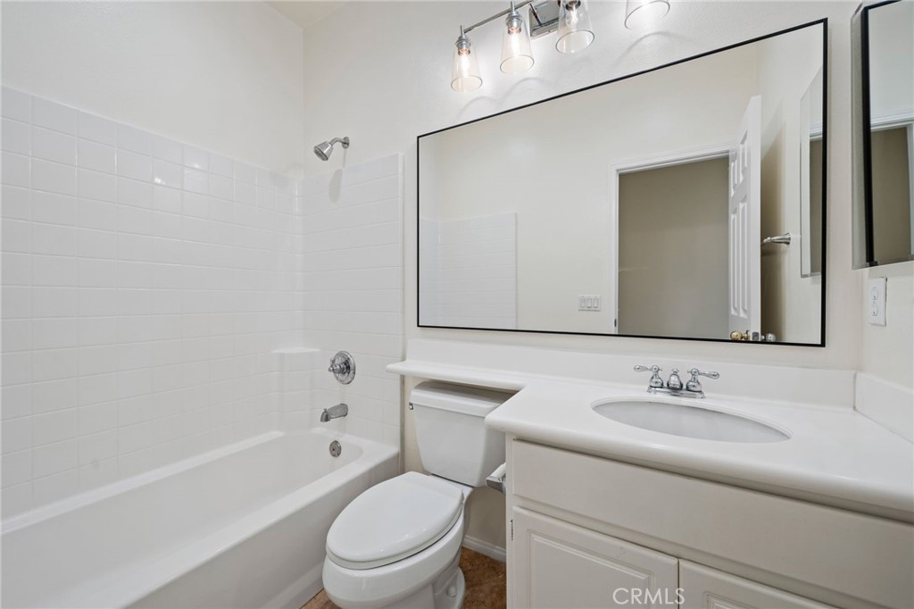 3 Wildflower Place Ladera Ranch, CA 92694 - Photo 31 of 32 a bathroom with a granite countertop sink a toilet and shower