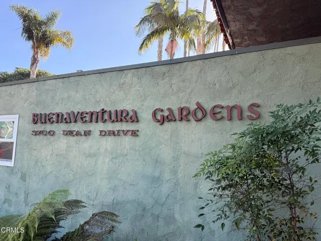 a street sign on a wall next to a wall