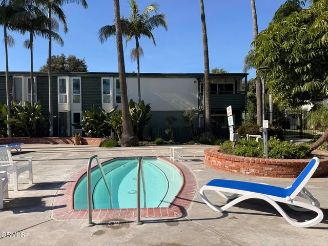 a swimming pool with outdoor seating and yard