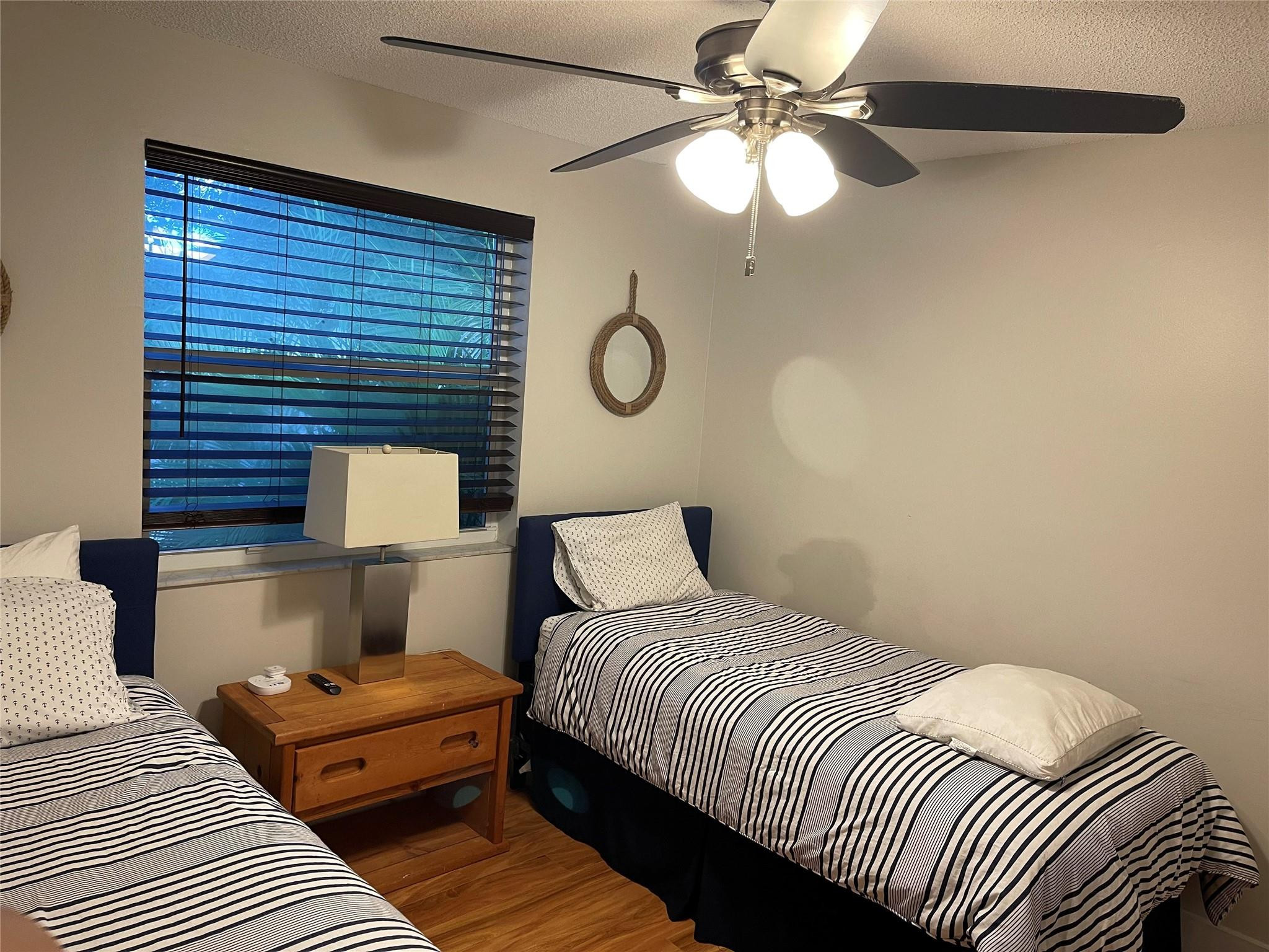 9871 Northwest 2nd Court Plantation, FL 33324 - Photo 11 of 21 a bedroom with a bed and a lamp