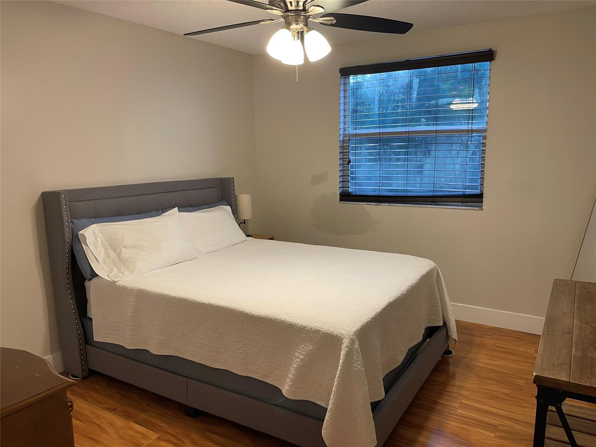 9871 Northwest 2nd Court Plantation, FL 33324 - Photo 10 of 21 a bed sitting in a bedroom next to a window