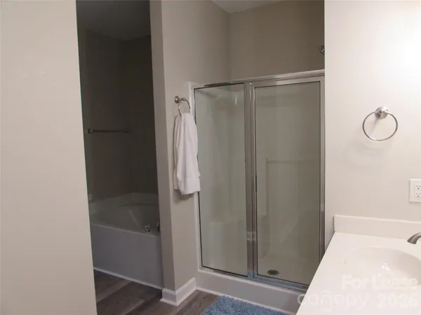 a bathroom with a glass shower door