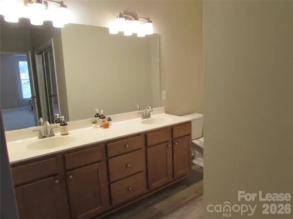 a bathroom with a double vanity sink and a mirror