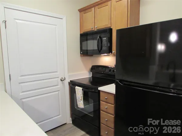 a kitchen with a refrigerator and stove