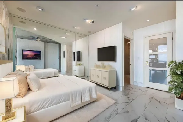 a bedroom with a bed and a television