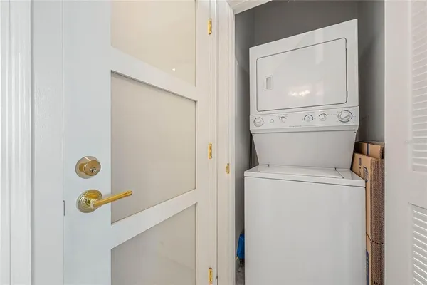 a kitchen with white cabinets and a refrigerator
