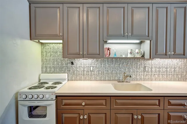 a view of a kitchen with sink and cabinets