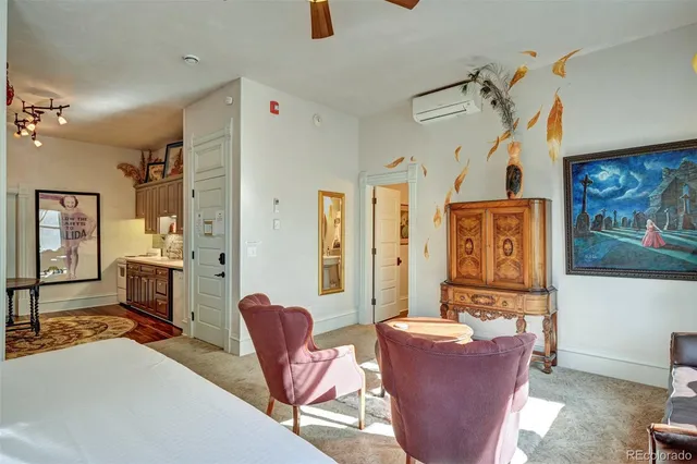 a living room with furniture a table and chairs