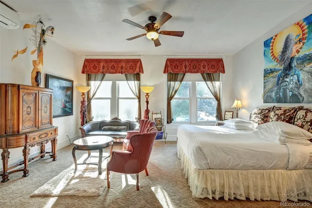 a bedroom with a bed and a chandelier