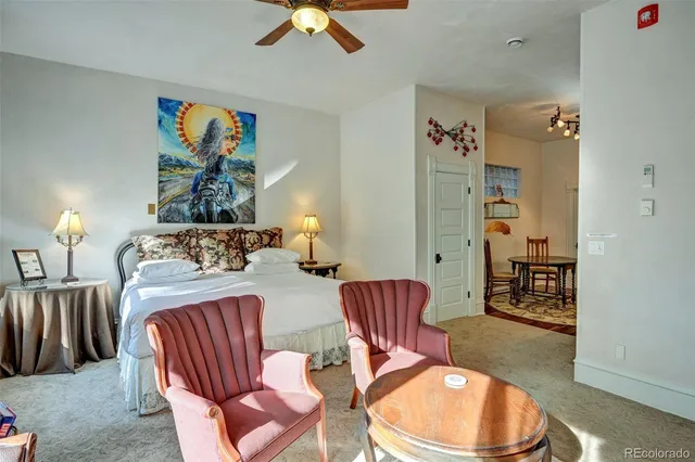 a bedroom with furniture and a wooden floor