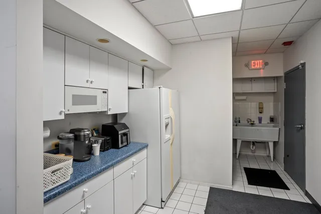 a view of a storage & utility room with a refrigerator