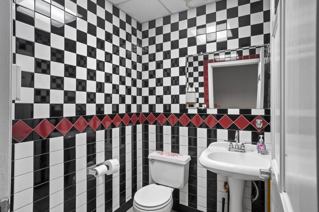 4425 Harlem Avenue Berwyn, IL 60402 - Photo 30 of 31 a bathroom with a sink a toilet and shower curtain