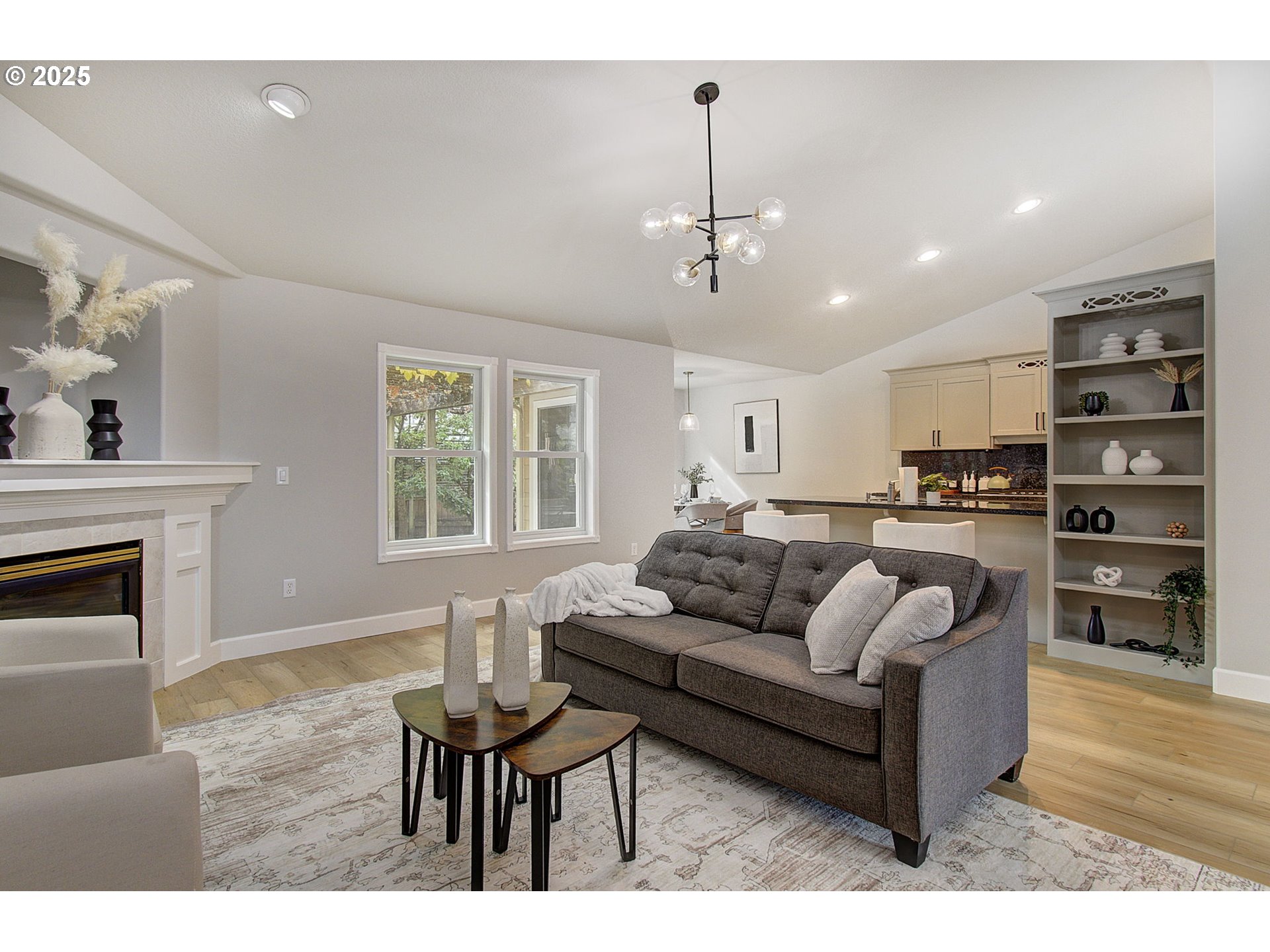 2513 Northwest 147th Street Vancouver, WA 98685 - Photo 13 of 42 a living room with furniture kitchen view and a fireplace