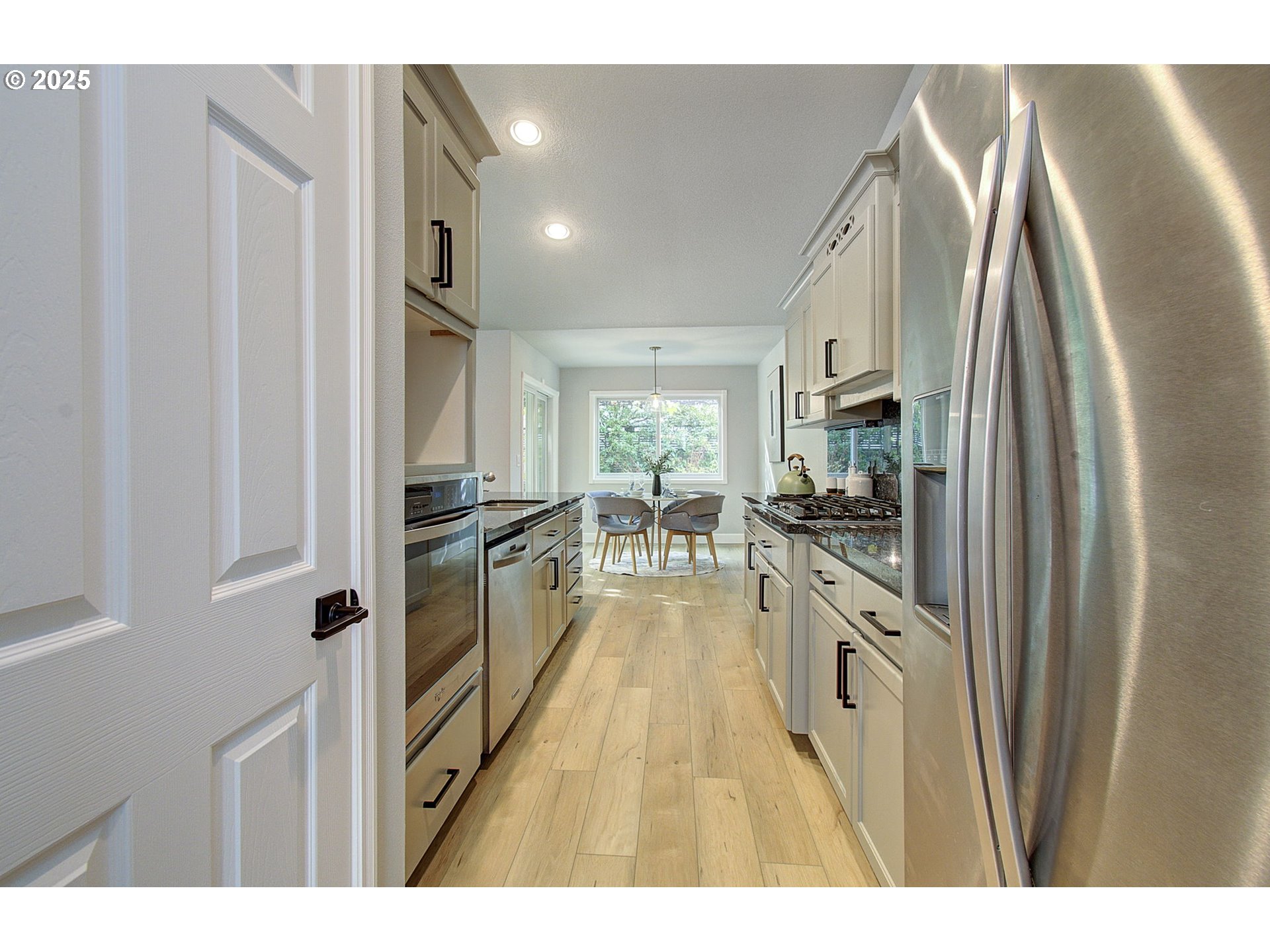 2513 Northwest 147th Street Vancouver, WA 98685 - Photo 14 of 42 a kitchen with stainless steel appliances granite countertop a refrigerator and a stove