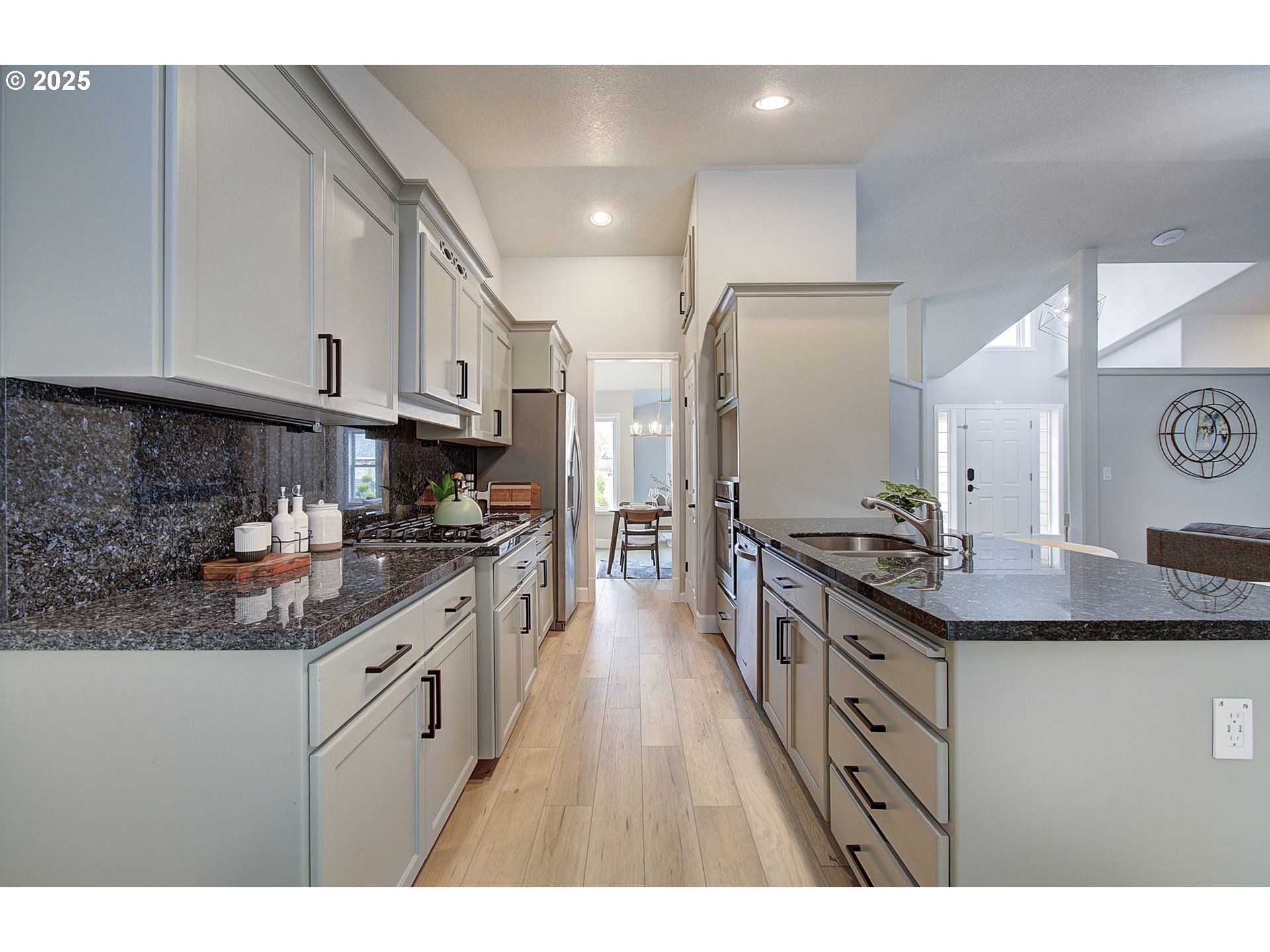 2513 Northwest 147th Street Vancouver, WA 98685 - Photo 16 of 42 a kitchen with stainless steel appliances granite countertop a stove a sink and a refrigerator