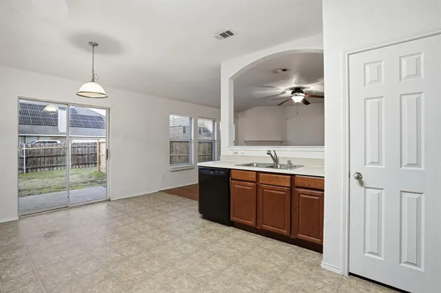 a kitchen with stainless steel appliances a stove top oven and a refrigerator
