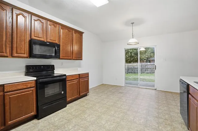 a spacious bathroom with a granite countertop sink a mirror and a bathtub