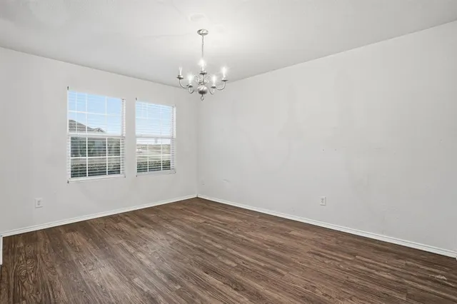 a kitchen with granite countertop a stove top oven microwave and cabinets