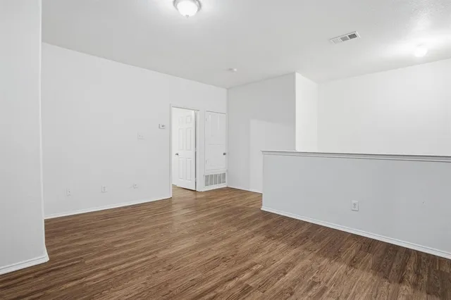 an empty room with wooden floor