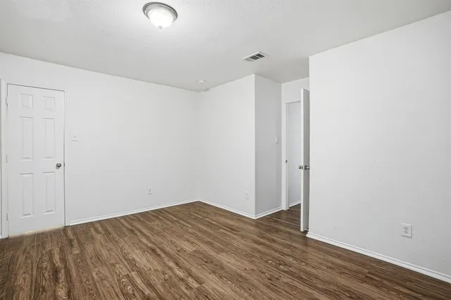 a view of a room with wooden floor
