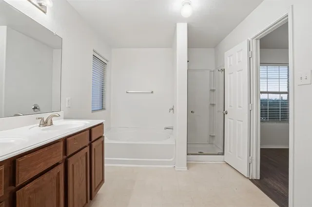 a spacious bathroom with a shower sink vanity and mirror