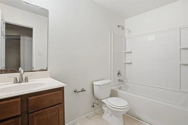 a bathroom with a sink toilet vanity and shower