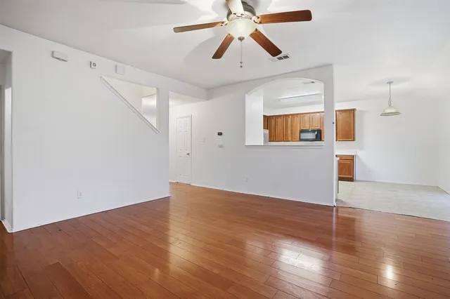 a view of empty room with wooden floor