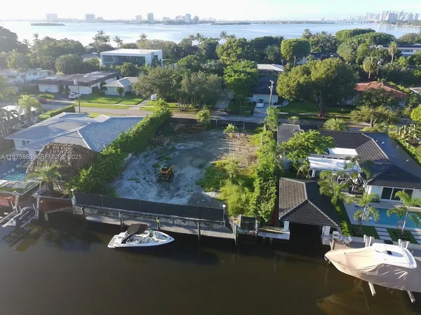 an aerial view of a house with swimming pool and a yard