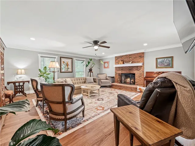 a living room with furniture a fireplace and a window