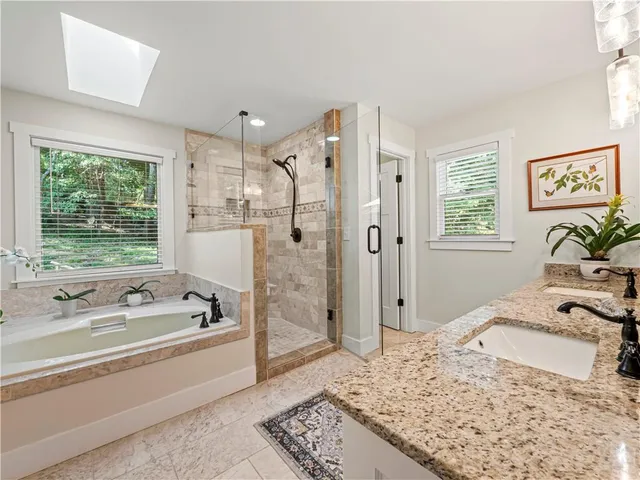 a bathroom with a tub sink and shower