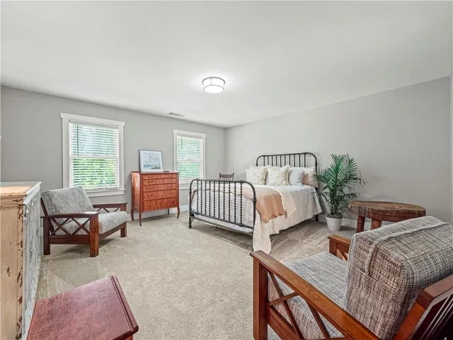 a bedroom with furniture and a window