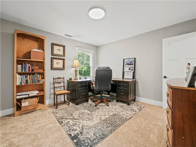 a view of a livingroom with workspace and a window