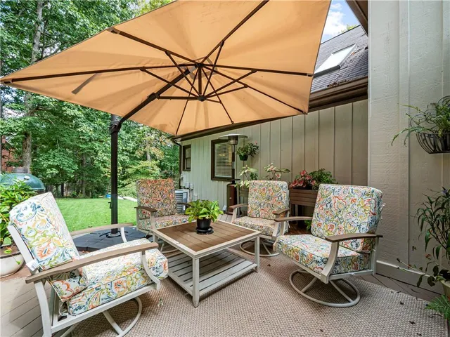 a view of patio with table and chairs under an umbrella